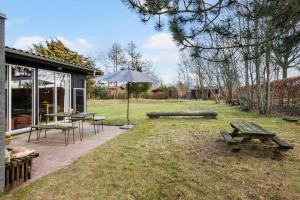 a patio with a picnic table and an umbrella at 30325-Odder-Rythiavang-22 in Odder