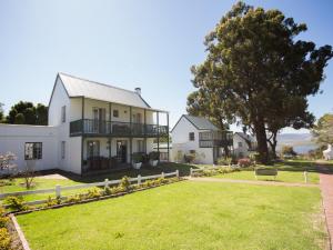 an exterior view of a house with a yard at Exquisite Cottage Twenty in Knysna