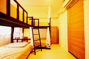 a bedroom with two bunk beds and a desk at Early Bird Hostel Ayutthaya in Phra Nakhon Si Ayutthaya