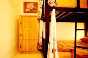 a bedroom with two bunk beds and a dresser at Early Bird Hostel Ayutthaya in Phra Nakhon Si Ayutthaya