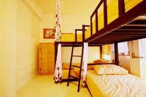 a bedroom with two bunk beds and a ladder at Early Bird Hostel Ayutthaya in Phra Nakhon Si Ayutthaya