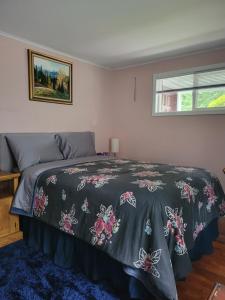 a bedroom with a bed with a bedspread with butterflies on it at Nice and cozy in Bremerton