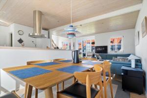a dining room and living room with a table and chairs at 40172-Juelsminde-Strandengen-30 in Juelsminde