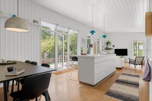 a kitchen and dining room with a table and chairs at 40171-Juelsminde-Poppelalle-29 in Juelsminde