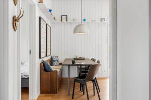 a dining room with a table and a chair at 40171-Juelsminde-Poppelalle-29 in Juelsminde +19 photos