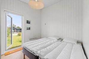 a bedroom with two beds and a large window at 40171-Juelsminde-Poppelalle-29 in Juelsminde