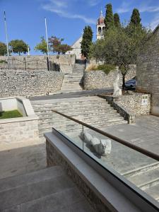 a set of stairs with a building in the background at Hotel Sveta Ana in Donji Humac