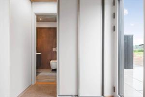 a bathroom with white walls and a toilet at 30477-Odder-Strandvaenget-2 in Odder +19 photos