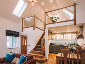 a living room and kitchen with a staircase in a house at An Dobhran - Ukc5752 in Dornie