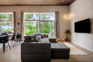 a living room with a couch and a tv at 30356-Odder-Hougaardsvej-36 in Odder