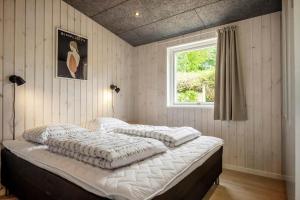a bed in a bedroom with a window at 30356-Odder-Hougaardsvej-36 in Odder