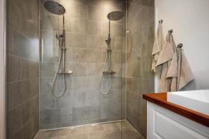 a bathroom with a shower with two shower heads at 30356-Odder-Hougaardsvej-36 in Odder +20 photos
