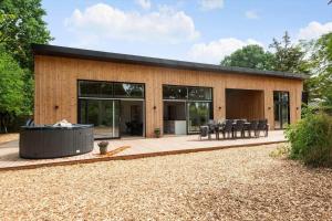 a house with a hot tub in front of it at 30356-Odder-Hougaardsvej-36 in Odder