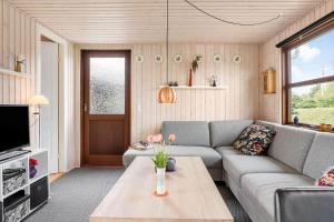 a living room with a couch and a table at 40607-Juelsminde-Pilevaenget-16 in Juelsminde