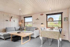 a living room with a couch and a table at 40607-Juelsminde-Pilevaenget-16 in Juelsminde