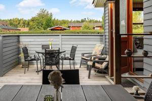 a patio with a table and chairs on a deck at 40607-Juelsminde-Pilevaenget-16 in Juelsminde