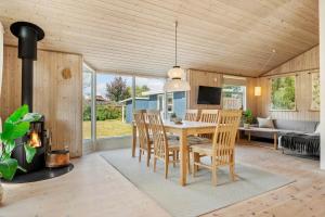a kitchen and dining room with a table and chairs at 30415-Odder-Strandparksvej-50 in Odder