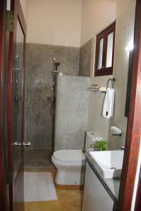 a bathroom with a toilet and a sink and a shower at Villa AyuSri in Ambalangoda +38 photos