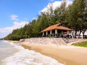 a building on the beach next to the water at Grand Blue Fantastic Pool / Sea View 1 BR unit in Mae Pim