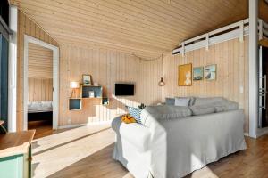 a living room with a couch and a tv at 30427-Saksild-Strandvaenget-31 in Saksild