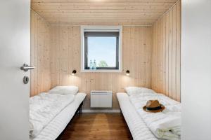 a room with two beds and a window at 30427-Saksild-Strandvaenget-31 in Saksild