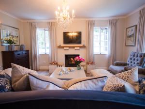 a living room with a couch and a fireplace at Exquisite Cottage Twenty in Knysna