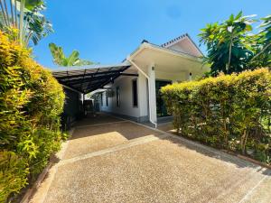 a house with a walkway in front of it at Duangtham luxury Pool Villa in Ban Khlong Haeng