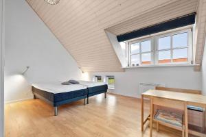 a large room with a bed and a window at 40173-juelsminde-Strandengen-46 in Juelsminde +27 photos