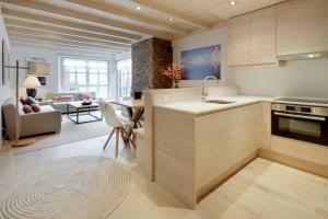 a kitchen and living room with a sink and a table at Val de Ruda Luxe 40 by FeelFree Rentals in Baqueira-Beret