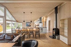 a living room and kitchen with a couch and a table at M235-Vaeggerlose-Kaninstien-33 in Bøtø By