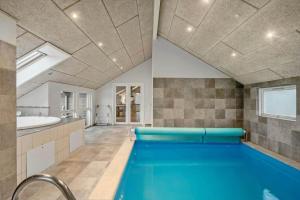 a swimming pool in a bathroom with a tub and a sink at M235-Vaeggerlose-Kaninstien-33 in Bøtø By