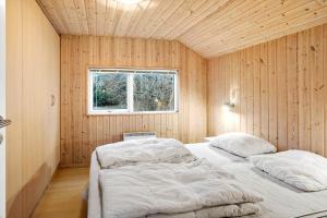 a bedroom with two beds in a room with a window at M235-Vaeggerlose-Kaninstien-33 in Bøtø By +11 photos