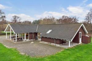 a large house with a roof on a field at M235-Vaeggerlose-Kaninstien-33 in Bøtø By