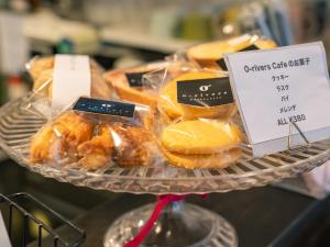 a tray of pastries on a plate with a sign at En- Hostel & Café bar in Amami