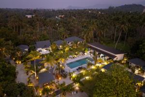 an aerial view of the resort at night at Moorea Boutique Resort Samui in Ban Tai +62 photos