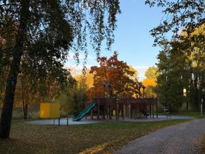 a playground with a slide in a park at Cozy Stay Marijampolė in Marijampolė