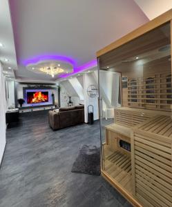 a room with a sauna with a couch and a fireplace at Phöenixpalace Whirlpool & Infarotsauna in Dortmund