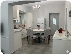 a kitchen with a table and chairs and a refrigerator at Niki's Dream House in Ierapetra +17 photos