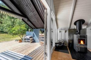 a patio with a woodburning stove on a deck at M368-Rodby-Spurvevaenget-11 in Rødby