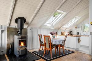 a kitchen and dining room with a table and a stove at M368-Rodby-Spurvevaenget-11 in Rødby +14 photos