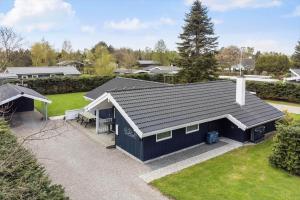 an aerial view of a blue house with a yard at M369-Vaeggerlose-Mimosevej-19 in Bøtø By