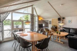a living room with a wooden table and chairs at M369-Vaeggerlose-Mimosevej-19 in Bøtø By +14 photos