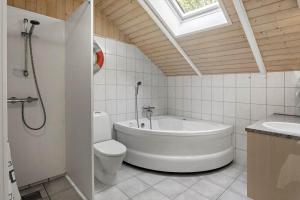 a bathroom with a tub and a toilet and a sink at M397-Vaeggerlose-Stolt-Henriksvej-111 in Bøtø By +12 photos