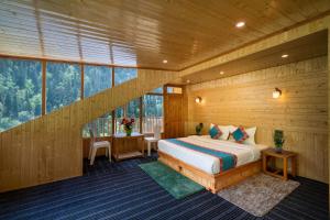 a bedroom with a bed in a room with windows at khwaab sojha in Alsindhi