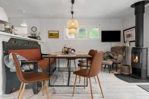 a living room with a table and a fireplace at 1608-Melby-Elna-Lassensvej-10 in Melby