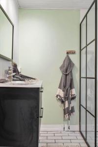 a towel hanging on a wall next to a tv at 1608-Melby-Elna-Lassensvej-10 in Melby +17 photos