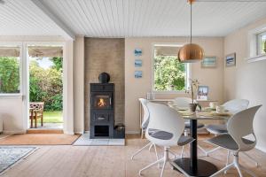 a dining room with a table and a wood stove at 1484-N-Gilleleje-Markvaenget-11 in Gilleleje