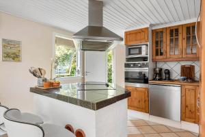 a kitchen with a counter and a stove top oven at 1484-N-Gilleleje-Markvaenget-11 in Gilleleje