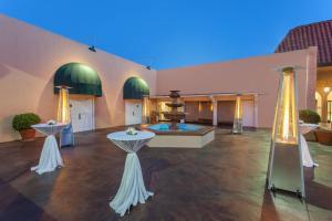 a large room with two tables and a fountain at Ramada by Wyndham Fresno North in Fresno