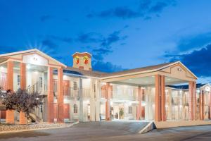 a large red brick building with a clock tower at Super 8 by Wyndham Van Horn in Van Horn